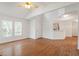 Bright living room with hardwood floors, large windows, and a partial view of the kitchen at 205 Mint Hill Dr, Cary, NC 27519