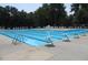 Large swimming pool with diving boards and lounge chairs surrounded by lush trees at 205 Mint Hill Dr, Cary, NC 27519