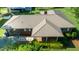 An aerial view displays a brick home with metal roof and a lovely yard at 2081 Stone Street Ext, Mebane, NC 27302