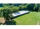 Aerial view of a long building set amidst lush greenery and expansive grassy field at 2081 Stone Street Ext, Mebane, NC 27302