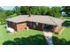 Aerial view of brick home with metal roof on a large green lot at 2081 Stone Street Ext, Mebane, NC 27302