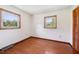 Bedroom with hardwood floors, two windows, and a closet at 2081 Stone Street Ext, Mebane, NC 27302