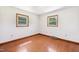 Bedroom featuring hardwood floors, bright white walls, and natural light from two windows at 2081 Stone Street Ext, Mebane, NC 27302