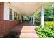 Covered front porch with swing and brick flooring for relaxing outdoors at 2081 Stone Street Ext, Mebane, NC 27302
