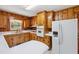 Charming kitchen with knotty pine cabinets and modern white appliances at 2081 Stone Street Ext, Mebane, NC 27302