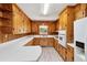 Inviting kitchen featuring knotty pine cabinetry, updated appliances, and ample counter space at 2081 Stone Street Ext, Mebane, NC 27302