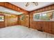 Cozy room with knotty pine walls, neutral floors, and natural light streaming in at 2081 Stone Street Ext, Mebane, NC 27302