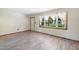 Bright living room with wood-look flooring, a window, and a view of the lawn at 2081 Stone Street Ext, Mebane, NC 27302