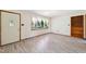 Bright living room featuring wood-look flooring, a window with curtains, and neutral wall paint at 2081 Stone Street Ext, Mebane, NC 27302