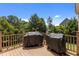 Wood deck with a railing overlooking a treed backyard, perfect for grilling at 2104 Brockfield Ct, Raleigh, NC 27614