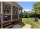 Backyard with a screened-in porch, patio, and lush landscaping, ideal for outdoor enjoyment at 2104 Brockfield Ct, Raleigh, NC 27614