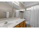 Bathroom features a single sink vanity, mirror, and shower with a white shower curtain at 2104 Brockfield Ct, Raleigh, NC 27614