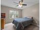 Bright bedroom with a window and ceiling fan, providing a cozy, comfortable retreat at 2104 Brockfield Ct, Raleigh, NC 27614