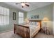 Cozy bedroom with a ceiling fan, two windows, and a comfortable queen-size bed at 2104 Brockfield Ct, Raleigh, NC 27614
