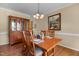 Inviting dining room with a wooden table set for four, a china cabinet, and a chandelier at 2104 Brockfield Ct, Raleigh, NC 27614