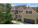 Beautiful two-story home featuring a brick foundation, lush lawn, attached garage, and a welcoming front entrance at 2104 Brockfield Ct, Raleigh, NC 27614