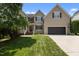 Charming two-story home with a well-manicured lawn, attached garage, and a classic brick-and-siding facade at 2104 Brockfield Ct, Raleigh, NC 27614