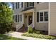 Inviting front entrance with a red door, white railings, brick steps, and tasteful landscaping at 2104 Brockfield Ct, Raleigh, NC 27614