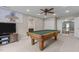Open game room with pool table, television, and natural light, perfect for entertainment at 2104 Brockfield Ct, Raleigh, NC 27614