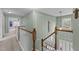Upstairs hallway featuring decorative trim and a view of the foyer at 2104 Brockfield Ct, Raleigh, NC 27614