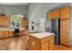 Well-lit kitchen with breakfast bar, stainless steel refrigerator, and a built-in desk at 2104 Brockfield Ct, Raleigh, NC 27614