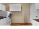 Well-equipped laundry room with modern washer and dryer and ample storage at 2104 Brockfield Ct, Raleigh, NC 27614
