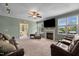 Inviting living room with a fireplace, large windows, and plush seating for relaxation and entertainment at 2104 Brockfield Ct, Raleigh, NC 27614
