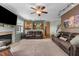 Open-concept living room with a view into the kitchen, showcasing a fireplace and comfortable leather sofas at 2104 Brockfield Ct, Raleigh, NC 27614