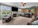 Cozy living room featuring a fireplace, plush carpet, and comfortable seating arrangements at 2104 Brockfield Ct, Raleigh, NC 27614