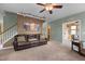 Cozy living room featuring a comfortable brown leather couch and earth-tone walls at 2104 Brockfield Ct, Raleigh, NC 27614