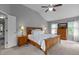 Main bedroom featuring neutral paint, a vaulted ceiling, and a wood bed frame at 2104 Brockfield Ct, Raleigh, NC 27614