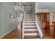 Elegant staircase with wood treads, white risers, and a decorative railing, leading to the upper level at 2104 Brockfield Ct, Raleigh, NC 27614