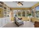 Bright sunroom with built-in bookcase, tile floors, and natural lighting at 2104 Brockfield Ct, Raleigh, NC 27614