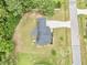 Aerial view of a property with a sprawling yard, driveway, and mature trees at 220 Oxfordshire Dr, Fuquay Varina, NC 27526