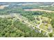 High aerial view of a suburban neighborhood featuring mature trees and well-maintained homes with generous lot sizes at 220 Oxfordshire Dr, Fuquay Varina, NC 27526