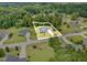 An aerial shot showcases a charming home with a long driveway nestled amongst lush greenery in a serene neighborhood at 220 Oxfordshire Dr, Fuquay Varina, NC 27526