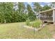 Expansive backyard featuring a lush lawn, garden beds, and covered patio at 220 Oxfordshire Dr, Fuquay Varina, NC 27526