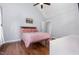 Bedroom featuring hardwood floors, large window, and a ceiling fan with a light fixture at 220 Oxfordshire Dr, Fuquay Varina, NC 27526