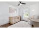 Bedroom with hardwood floors, bright window, and neutral tones, creating a calming and inviting space at 220 Oxfordshire Dr, Fuquay Varina, NC 27526