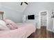 Bedroom featuring hardwood floors, large window, a TV, and a ceiling fan with a light fixture at 220 Oxfordshire Dr, Fuquay Varina, NC 27526