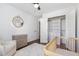 Bedroom with hardwood floors, bright window, neutral tones, closet and chair at 220 Oxfordshire Dr, Fuquay Varina, NC 27526
