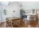 Bright dining area with a rustic wooden table, views to kitchen, and modern lighting at 220 Oxfordshire Dr, Fuquay Varina, NC 27526