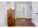 Inviting foyer showcasing hardwood floors, a decorative mirror, and a classic wooden cabinet at 220 Oxfordshire Dr, Fuquay Varina, NC 27526