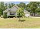 Attractive home featuring a neatly trimmed lawn, mature landscaping, and an attached garage at 220 Oxfordshire Dr, Fuquay Varina, NC 27526