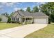 Lovely single-Gathering home featuring a well-maintained lawn, covered porch, and a two-car garage at 220 Oxfordshire Dr, Fuquay Varina, NC 27526