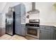 Kitchen featuring stainless steel appliances, gray cabinets, and white subway tile backsplash at 220 Oxfordshire Dr, Fuquay Varina, NC 27526