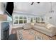 Bright and airy living room featuring a large sectional sofa, fireplace, and natural light at 220 Oxfordshire Dr, Fuquay Varina, NC 27526