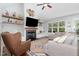 Cozy living room with a fireplace, decorative shelves, hardwood floors, and comfortable seating at 220 Oxfordshire Dr, Fuquay Varina, NC 27526