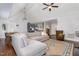 Bright living room featuring a large sectional sofa, vaulted ceilings, and hardwood floors at 220 Oxfordshire Dr, Fuquay Varina, NC 27526