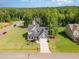 Aerial view of home on a large lot with mature trees, well-manicured lawn, and long driveway at 220 W Amber Oak Dr, Selma, NC 27576